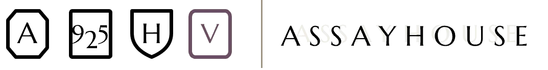 Volume Five's hallmark set: the three sitewide marks — A, 925, H — alongside the volume's own Roman numeral V mark in Plum, next to the Assayhouse wordmark